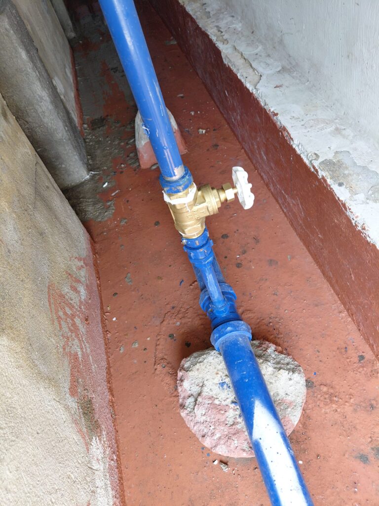 New brass gate valve on blue water pipe, Nassim Hill